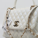 CHANEL Handbag 20K Iridescent White Caviar Quilted Coco Handle Medium Light Gold Hardware - Redeluxe