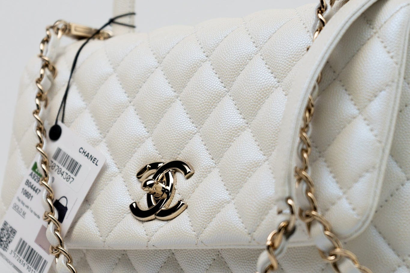 CHANEL Handbag 20K Iridescent White Caviar Quilted Coco Handle Medium Light Gold Hardware - Redeluxe