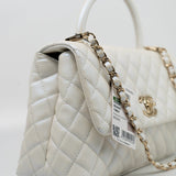 CHANEL Handbag 20K Iridescent White Caviar Quilted Coco Handle Medium Light Gold Hardware - Redeluxe