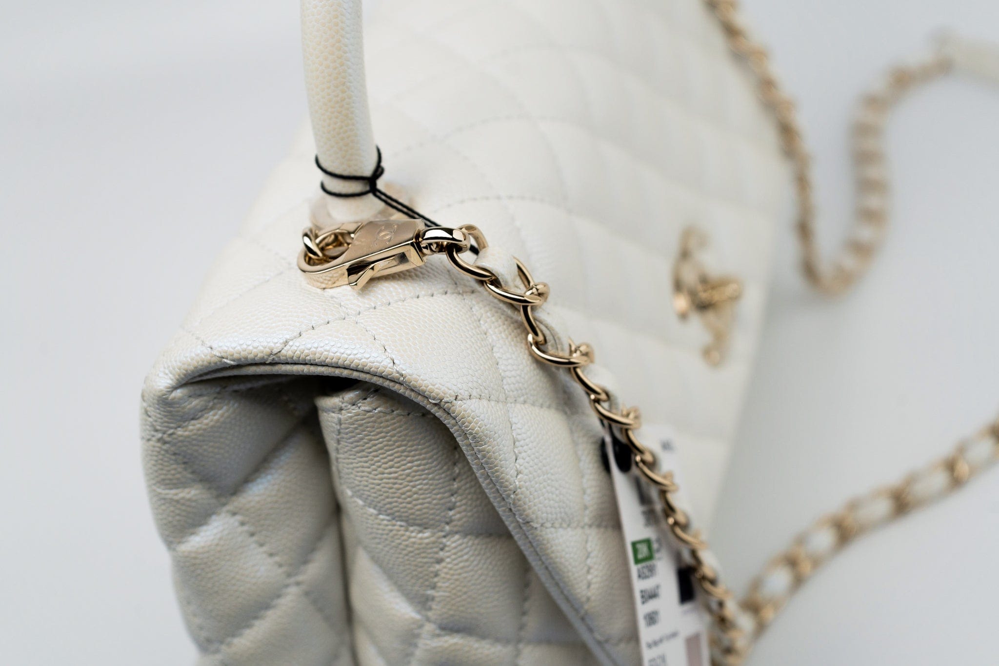 CHANEL Handbag 20K Iridescent White Caviar Quilted Coco Handle Medium Light Gold Hardware - Redeluxe