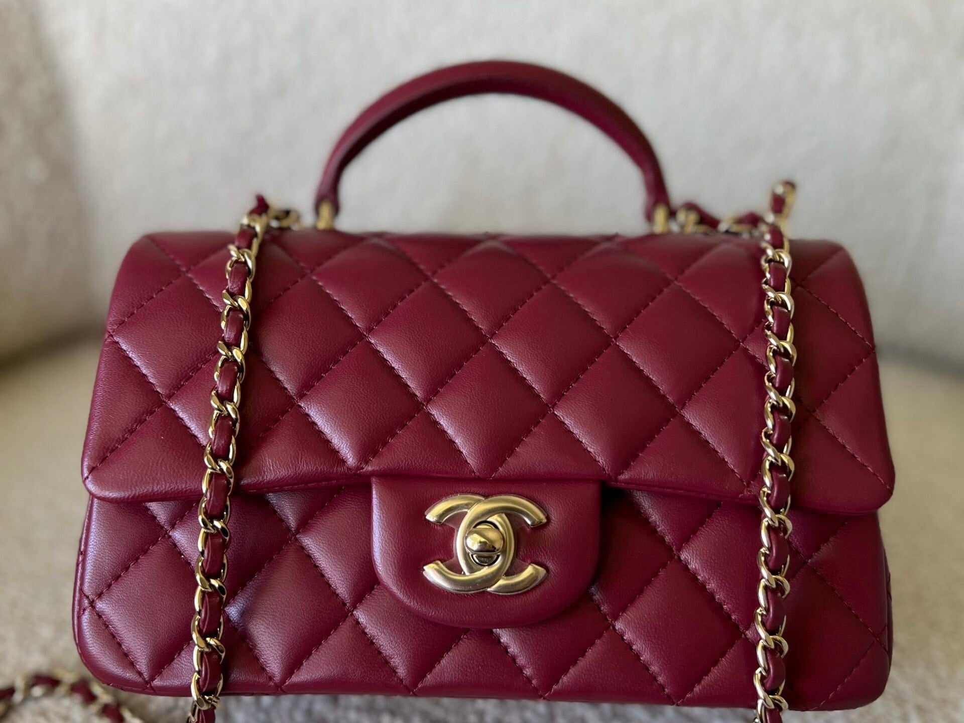 CHANEL Handbag 22A Mini Burgundy Lambskin Quilted Single Flap with Top handle Light Gold Hardware - Redeluxe