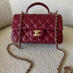 CHANEL Handbag 22A Mini Burgundy Lambskin Quilted Single Flap with Top handle Light Gold Hardware - Redeluxe