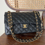 CHANEL Handbag Black Black Caviar Quilted Jumbo Classic Flap Gold Hardware - Redeluxe