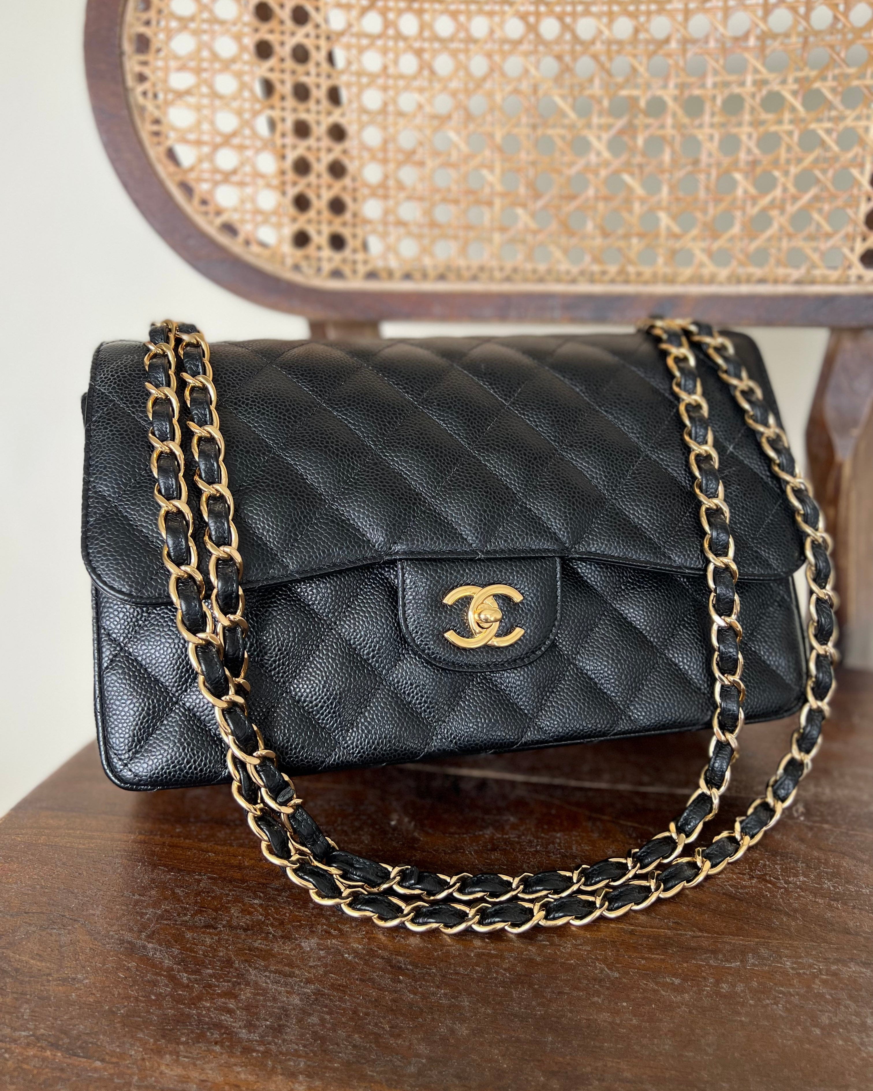 CHANEL Handbag Black Black Caviar Quilted Jumbo Classic Flap Gold Hardware - Redeluxe
