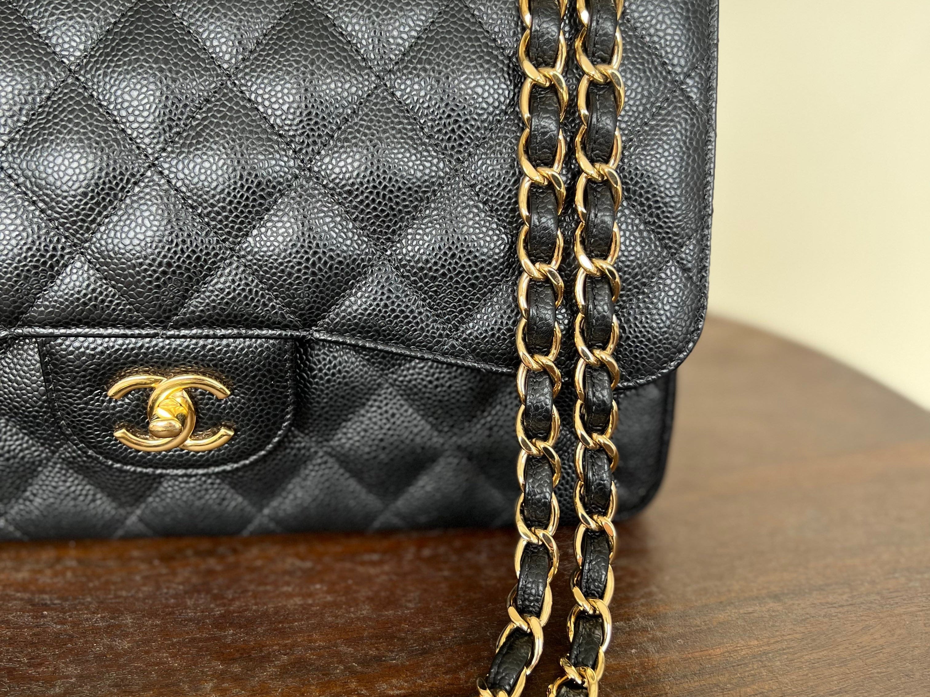 CHANEL Handbag Black Black Caviar Quilted Jumbo Classic Flap Gold Hardware - Redeluxe