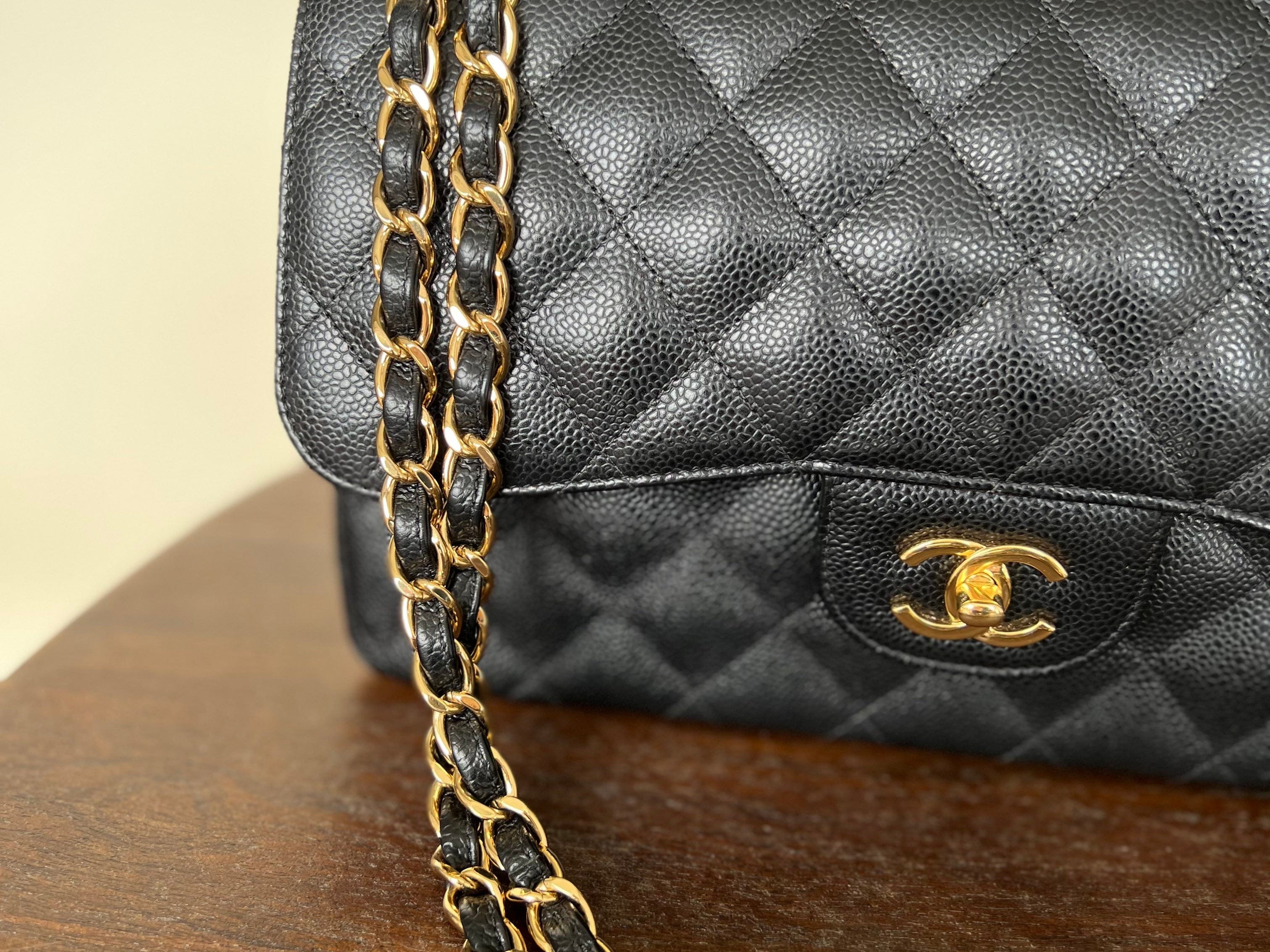 CHANEL Handbag Black Black Caviar Quilted Jumbo Classic Flap Gold Hardware - Redeluxe