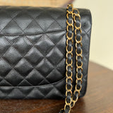 CHANEL Handbag Black Black Caviar Quilted Jumbo Classic Flap Gold Hardware - Redeluxe