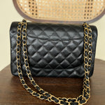 CHANEL Handbag Black Black Caviar Quilted Jumbo Classic Flap Gold Hardware - Redeluxe