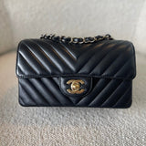 CHANEL Handbag Black Mini Rectangular Lambskin Chevron Light Gold Hardware - Redeluxe