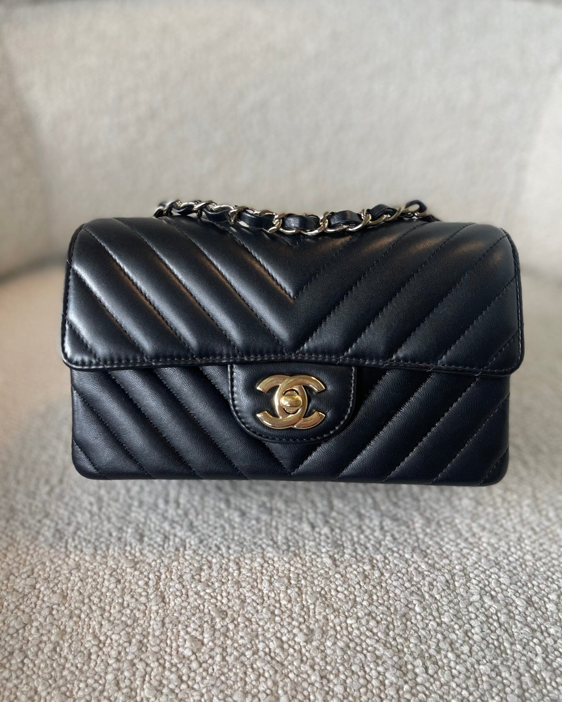 CHANEL Handbag Black Mini Rectangular Lambskin Chevron Light Gold Hardware - Redeluxe