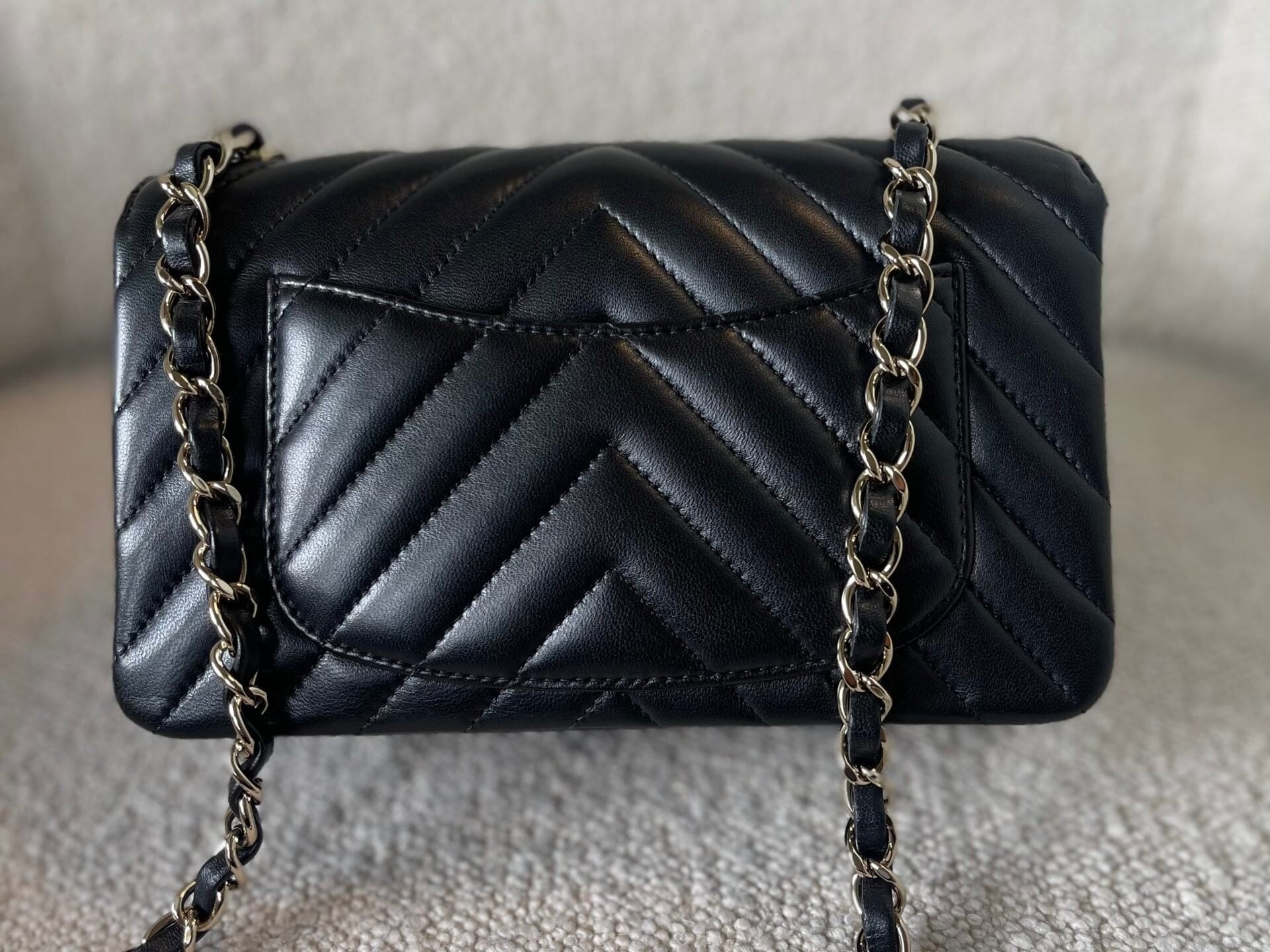 CHANEL Handbag Black Mini Rectangular Lambskin Chevron Light Gold Hardware - Redeluxe