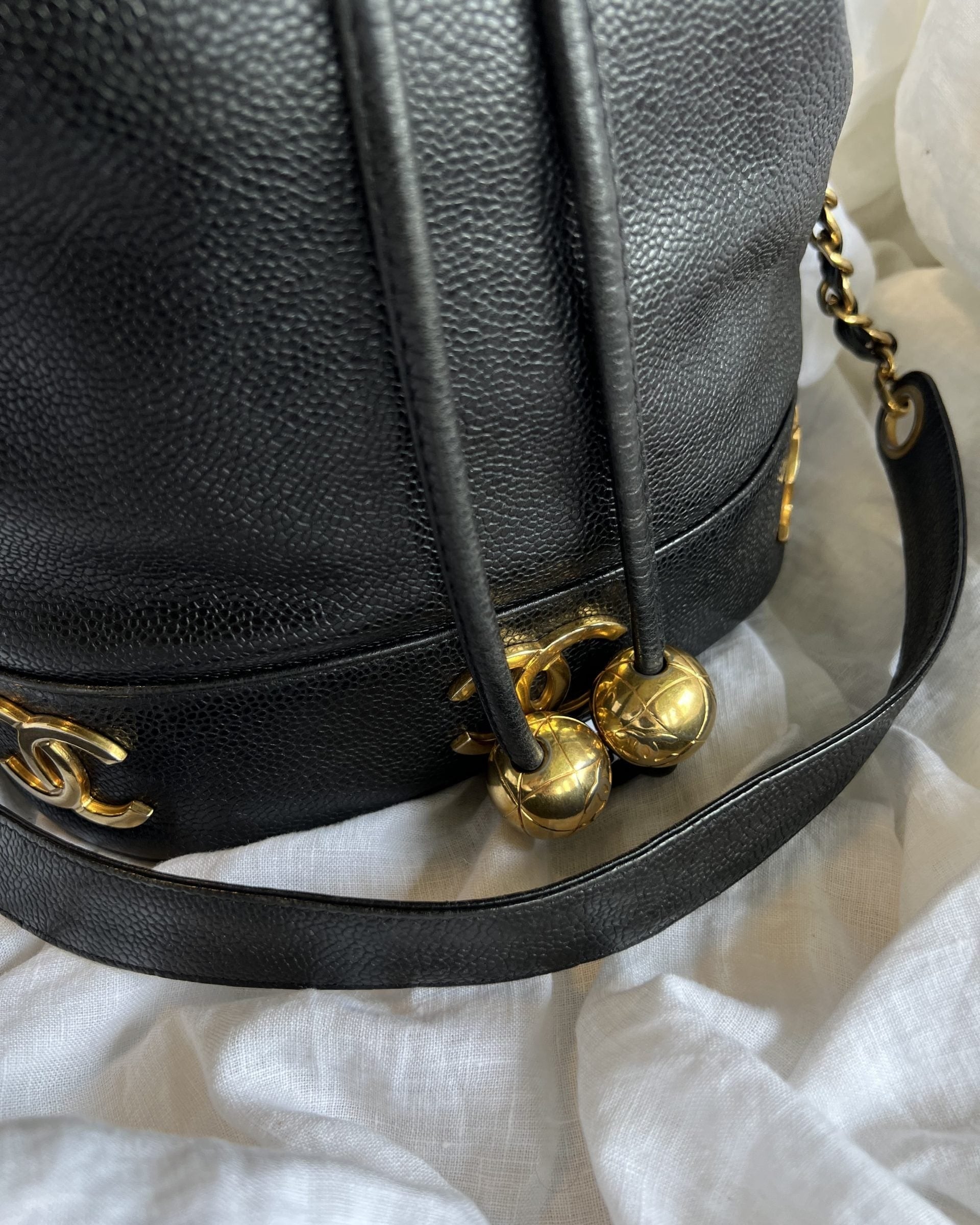 CHANEL Handbag Chanel Black Caviar Vintage Drawstring Gold Hardware - Redeluxe