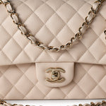 CHANEL Handbag Cream 20C Light Beige Caviar Quilted Classic Flap Medium Light Gold Hardware - Redeluxe