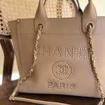 CHANEL Tote CHANEL LIGHT BEIGE MEDIUM DEAUVILLE SHOPPING TOTE STUDDED AGED HARDWARE - Redeluxe
